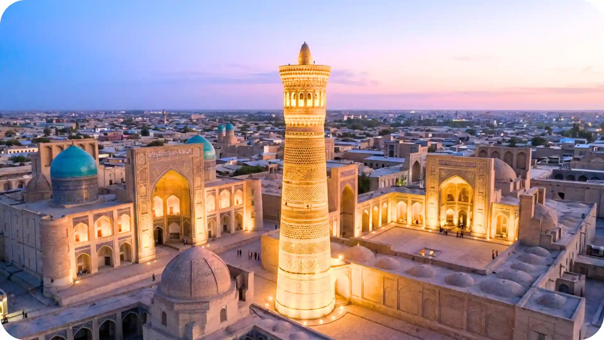 Kalyan Minaret and Po-i-Kalyan mosque complex in Bukhara Uzbekistan glowing at sunset with turquoise domes, historic Silk Road skyline, and golden city lights – Ghumora heritage journey